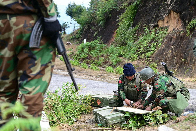 Ta'ang National Liberation Army fighters prepare their weapons amid clashes with Myanmar's military in Namhsan town, in the northern Shan State, on December 13, 2023